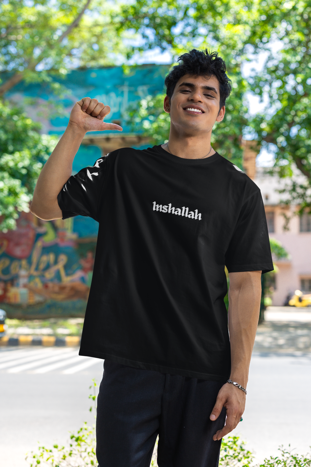 Man wearing black Inshallah T-shirt